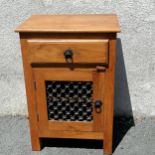 Hardwood bedside cabinet with cast iron detail. In good used condition.