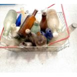 Vintage shopping basket containing qty of bottles inc Devonish, Tizer, blue Optrex bottles etc