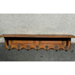 Oak wall shelf with coat hooks. 100cm long. In good used condition.