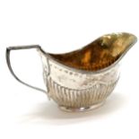 Small silver half fluted cream jug with original gilt interior - 28g & 5cm high