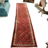 Long red grounded runner - 420cm x 80cm - has a stain