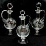 Set of 3 x wine carafes with etched decoration. In good condition- tallest 32cm