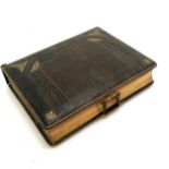 Antique leather bound photograph album (come away from spine) containing family portraits of the