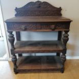 Antique carved oak buffet with green man carved to the upstand and drawer handles, crack to the