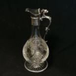 Silver mounted glass claret jug with engraved grape / vine decoration & lion detail to handle by