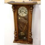 Oak cased wall clock with a gong strike mechanism with key & pendulum - 68cm x 45cm ~ has crack to
