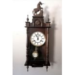 Dark wood cased wall clock with horse detail to the top 82cm high with pendulum and no key