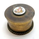 Continental gilt brass circular table box with porcelain plaque of cupid on the lid - 11.5cm