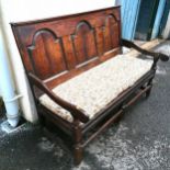 Antique Oak bench seat with arched rear panels with pegged joints. Has seat pad and matching cushion