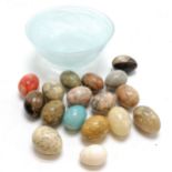 17 x mostly alabaster stone eggs in a glass bowl