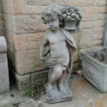 Statue of a cherub holding a basket of fruit. 84cm high. In good used condition.