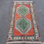 Blue and pink wool rug, in good used condition.