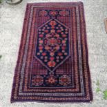 Blue and red grounded Persian wool rug. in good used condition. 120cm x 196cm