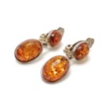Pair of silver clip-on amber earrings - 2.5cm drop & 6.2g total weight - SOLD ON BEHALF OF THE NEW