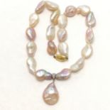 Strand of large baroque freshwater pearls with an 18ct marked gold diamond set pendant drop and a