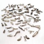 Qty of silver charms inc bullet, body boarders, pasties, skull, flippers, golf bag etc - total