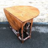 Antique oak gateleg table with barley twist leg detail. 95cm wide x 74cm high x 116cm extended (