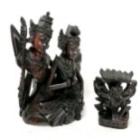 An Asian hardwood carving of 2 deity seated figures 25cm high T/W a smaller carved guardian figure