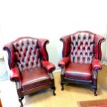 Pair of Vintage Ox blood leather wing armchairs with button detail to the back and separate seat