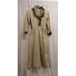 Early 19th century, stone coloured dress with lace trim, slight staining to front, otherwise in good