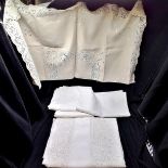 Box of crochet edged and white embroidered tablecloths
