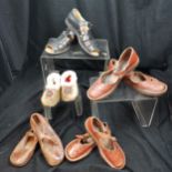 Box of vintage childrens shoes in used condition, including seals skin slippers.