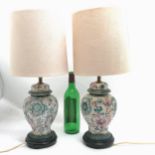 Pair of oriental style baluster china lamps on black turned wooden bases - total height 53cm