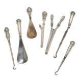 Sterling silver handled - 2 shoehorns, 3 button hooks (1 a/f), 2 curling tongs (longest 18cm)
