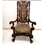 Antique carved open armchair with high back and upholstered seat. 66cm wide x 125cm high.