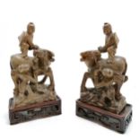 Antique pair of Chinese hand carved soapstone figures of men with water buffalo on hand carved