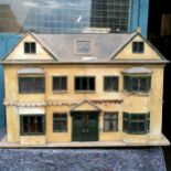 Antique hand made dolls house with break front windows, the portico front door having twin doors