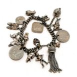 Silver charm bracelet set with various charms inc coins etc - 67g total weight