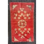 An antique circa 1900 Oriental red ground wool rug, 68 x 116 cm has wear.