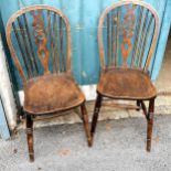 A pair of oak and elm seated wheel back kitchen chairs with single stretcher to turned legs. 90cm