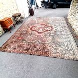 Large antique pink, blue and black wool rug 345 cm wide. Has wear and a small hole to 1 corner