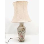 Ceramic lamp base with floral decoration and silk shade. 66cm total height. In good condition.