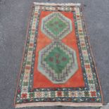 Blue and pink wool rug, 245cm x 135cm, in good used condition.