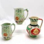 Pair of Beswick graduated jugs, 1 A/F, T/W a Myott and Sons colourful jug, 19cm high. In good