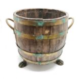 Antique coopered brass banded barrel shaped coal bin with 2 brass handles terminating on 3 hairy paw