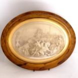 Antique plaster relief oval panel in a scumbled frame with domed glass. 46cm x 38cm. signed