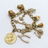 9ct hallmarked gold charm bracelet with 1912 George V sovereign & other charms inc shamrock, penny