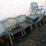 Cast iron set of table and 4 armchairs with teak seats. Table 115cm x 57cm x 60cm high. In good used