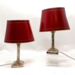 Pair of silver plated lamp Bases as Corinthian columns, with red shades.39cm high.