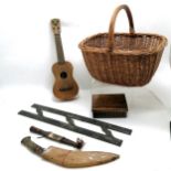 Wicker basket (44cm across) containing a large antique charting rule, ukulele, olive wood box, kukri