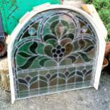 Part of an arched stained glass window in a wooden frame - 80cm wide x 88cm high
