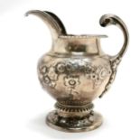 Antique silver embossed cream jug hallmarked London 1812. 240g. 8cm high. fractures to both sides of