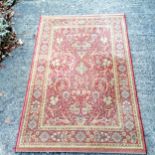 Terracotta grounded New Zealand wool rug by Vespucci - 120cm x 180cm in used condition