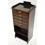 An Edwardian five drawer music cabinet with Art Nouveau brass handles and two shelves to the lower