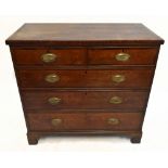 An early 19th century oak and mahogany crossbanded chest of two short over three long drawers,