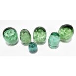 Six Victorian green glass dump weight, each with encased floral decoration, height of largest